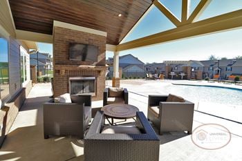 Outdoor pavilion with fireplace, flat screen tv, and food area